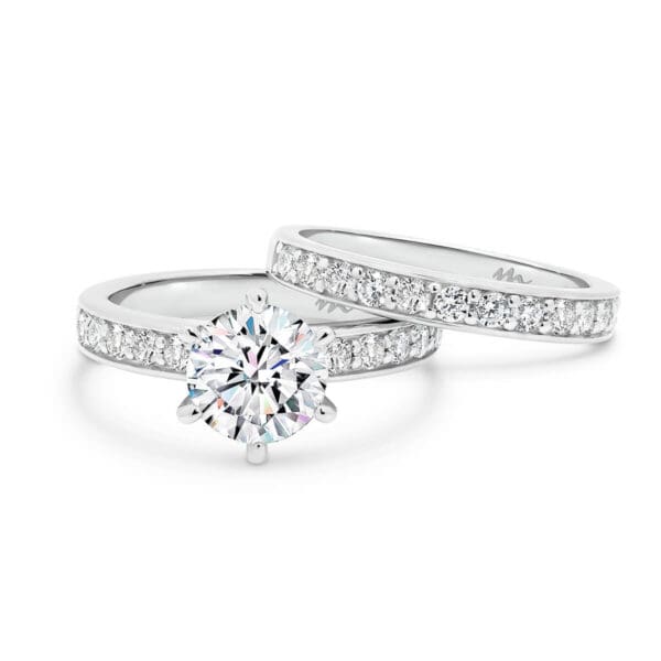 Isabelle 6.5-7.0 Round Moissanite ring with pave-set band