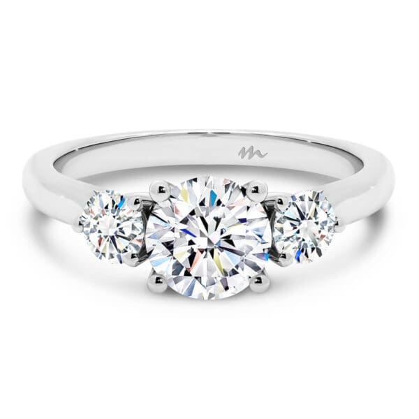 Theresa Three Stone Moissanite Engagement Ring With 1.00 Carat Round Centre Stone And Heart Shaped Gallery