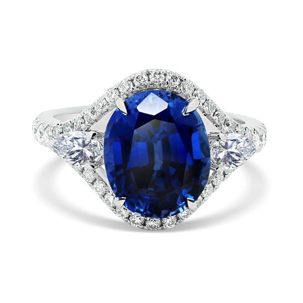 Acacia Blue Oval sapphire ring with pear cut side stones and delicate prong set outer halo