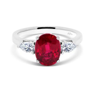 Cassic Red Oval Ruby Trilogy With Pear Cut Side Stone On Tapered Band
