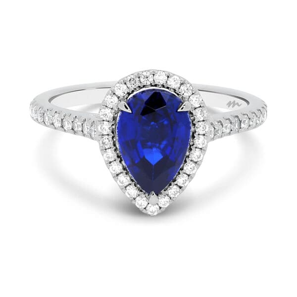 Faith 10x7 ring with a large pear in a halo design and encrusted stones.