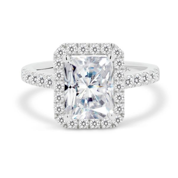 Elongated radiant engagement ring with halo and prong set band