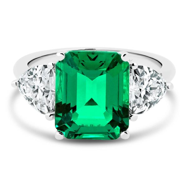 Tulip emerald trilogy with two trillion side stones on knife-edge band