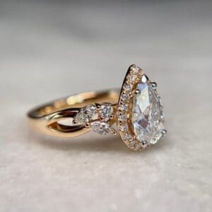 Custom Engagement Ring With Pear Cut Centre Stone, Diamond Encrusted Halo And Intricate Side Detailing