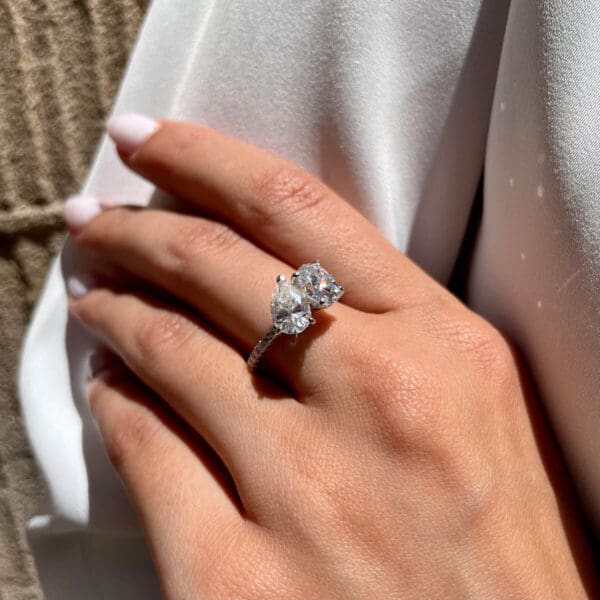 Model Wears Nicolette 9X6 White Gold Moissanite Oval Pear Toi Et Moi Engagement Ring