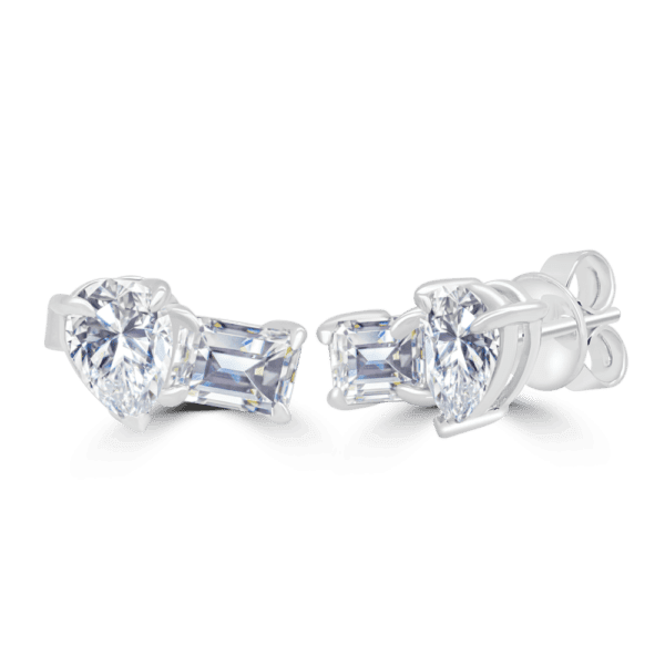 Model wears Jeanette Grande 7x5 white gold Moissanite emerald pear cut prong set Toi Et Moi earrings