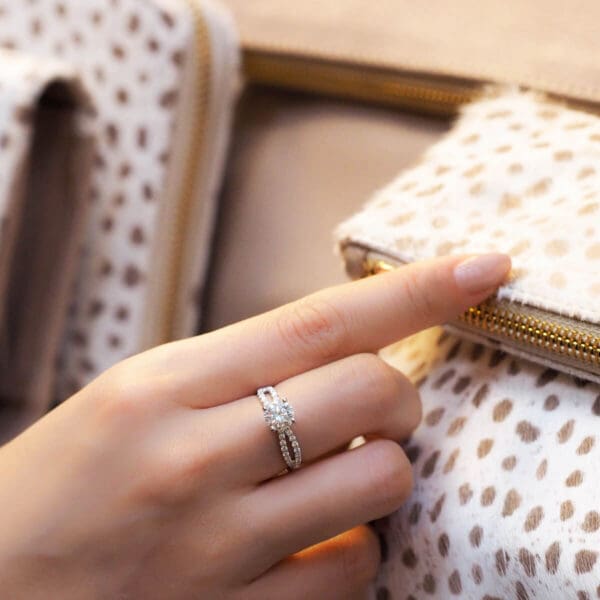 Model Wears Frida Round 6.5 Diamond 4 Prong Infinity Crossover Accented Band White Gold Ring