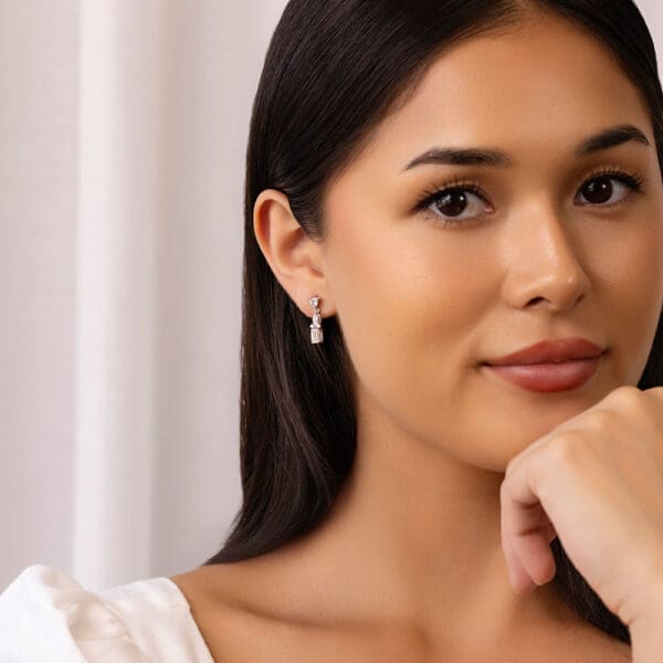 Model Wears Kiana White Gold Diamond Trillion Marquise Accent Emerald Drop Earrings