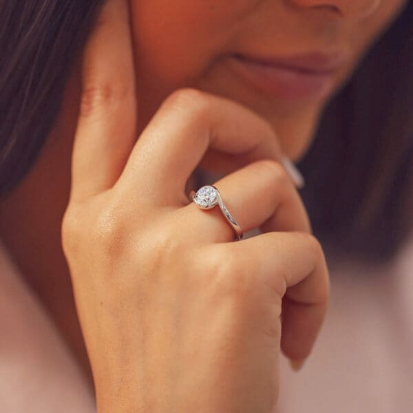 Model Wears Liza 6.5 White Gold Diamond Round Twisted Semi Bezel Halo Solitaire Band Ring