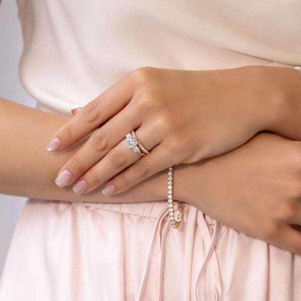 Model Wears Angela 2.0 U Prong Half Set Wedding Band Meghan 8.0 Yellow Gold Moissanite Prong Set Crossover Trilogy Ring