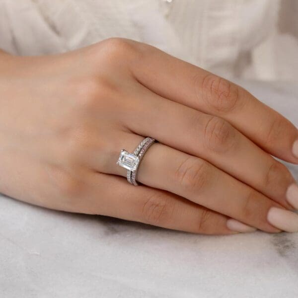 Model Wears Angela Pink 1.1 White Gold Diamond U Prong Half Set Wedding Band Rosewood Emerald 9X7 Moissanite Open Basket Ring