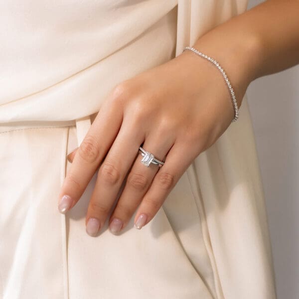Model Wears Angelica 1.1 White Gold Diamond U Prong Set Wedding Band Holly Emerad 2.00Ct Solitaire Ring