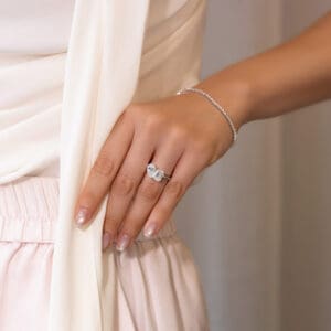 Model Wears Annette 10X7 White Gold Moissanite Emerald Pear Cut Toi Et Moi Ring