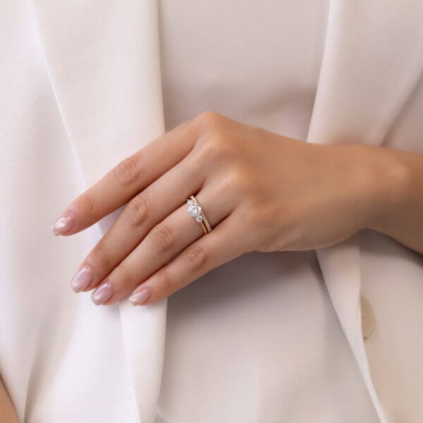 Model Wears Ava A Yellow Gold Diamond Prong Set Wedding Band Lawnton 6.5 Knife Edge Tapered Trilogy Ring