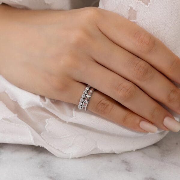 Model Wears Carmen 2.0 White Gold Alternating Pink Diamond Channel Set Wedding Band Gracie 2.5 Scalloped Round Shared Prong Ring