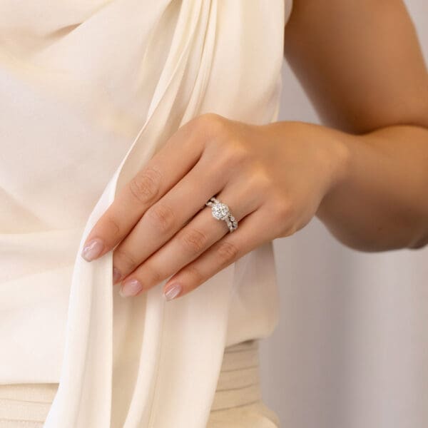 Model Wears Daphne A White Gold Diamond Round Marquise Art Deco Wedding Band Daphne Round 6.5 Moissanite Floral Halo Ring