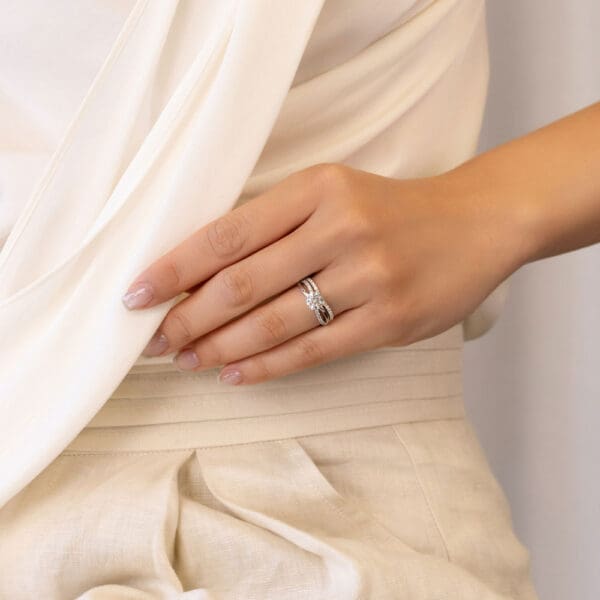 Model Wears Freya A White Gold Diamond Prong Set V Shaped Wedding Band Freya Round 6.5 Crossover Infinity Ring
