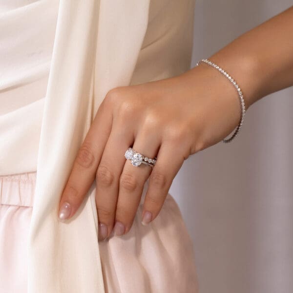 Model Wears Gracie 2.0 Platinum Scalloped Round Band Lisette 9X7 White Gold Moissanite Round Ovall Cut Toi Et Moi Ring