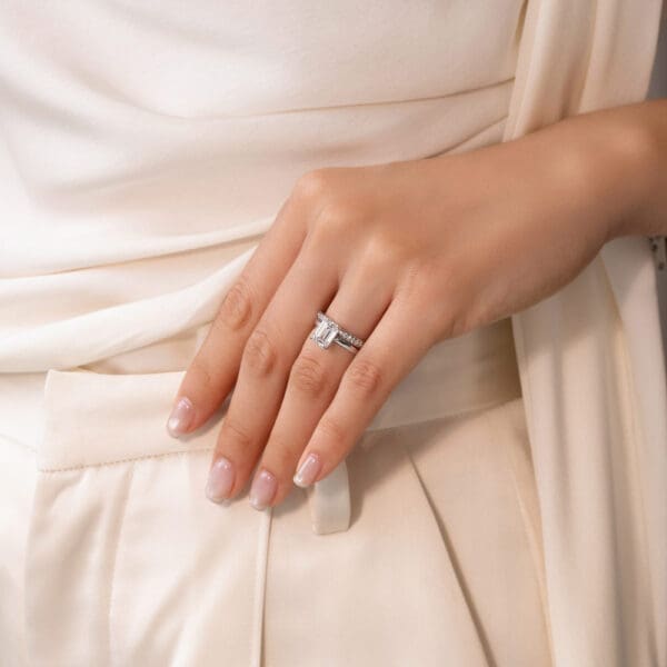 Model Wears Marie 1.3 White Gold Diamond Pinched Centre Pave Wedding Band Holly Emerald 2.00Ct Solitaire Ring