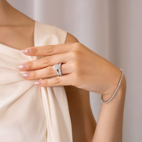 Model Wears Millie 2.5 White Gold Moissanite Pave Set Wedding Band Fiona Round 9.0 Four Prong Solitaire Ring