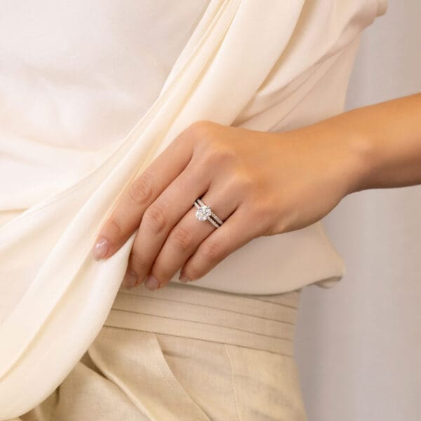 Model Wears Rosewood A White Gold Diamond Straight Prong Set Wedding Band Rosewood Oval 9X7 Moissanite Open Basket Ring
