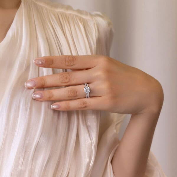 Model Wears White Gold Moissanite Angelica 1.5 U Prong Set Wedding Band Harmony Cushion 7.5 Stone Set Under Rail Bridge Ring