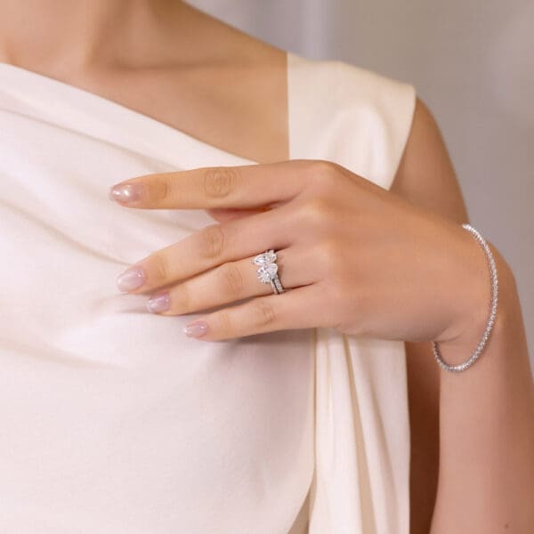 Model Wears White Gold Moissanite Angelica 2.0 U Prong Set Wedding Band Aurelie 11X5.5 Marquise Pear Cut Toi Et Moi Ring