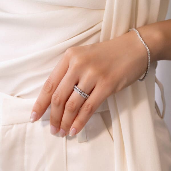 Model Wears White Gold Moissanite Carmen 1.3 Channel Set Wedding Band Gracie 2.0 Scalloped Round Shared Prong Ring