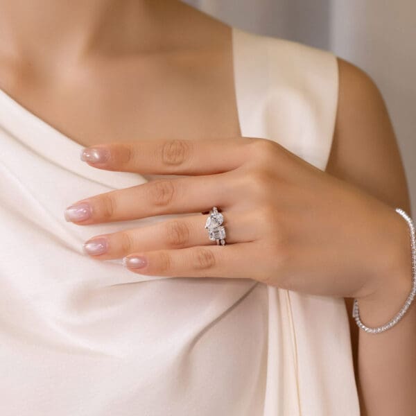 Model Wears White Gold Moissanite Evie Marquise Round Shared Prong Wedding Band Annette 10X7 Emerald Pear Toi Et Moi Ring