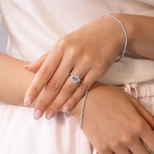 Model–Wears White Yellow Gold Moissanite Emma Round Marquise Wedding Band Aubrey Emerald 9X7 Double Prong Trilogy Ring