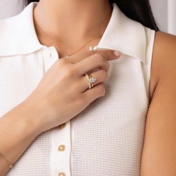Model Wears Holly Marquise 1 51Ct Yellow Gold Diamond 6 Prong Solitaire Ring Elle Moissanite Marquise Round Wedding Band