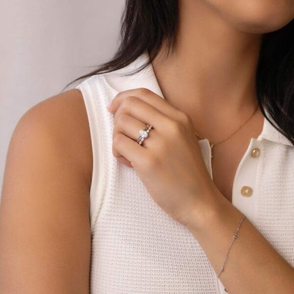 Model Wears Holly Pear 9X6 White Gold Diamond 3 Prong Solitaire Ring Eden Moissanite Marquise Shared Prong Wedding Band