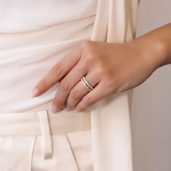 Model Wears Jodie Yellow Gold Moissanite Asymmetrical Round Bezel Set Band Roxie 2 0 Wedding Ring