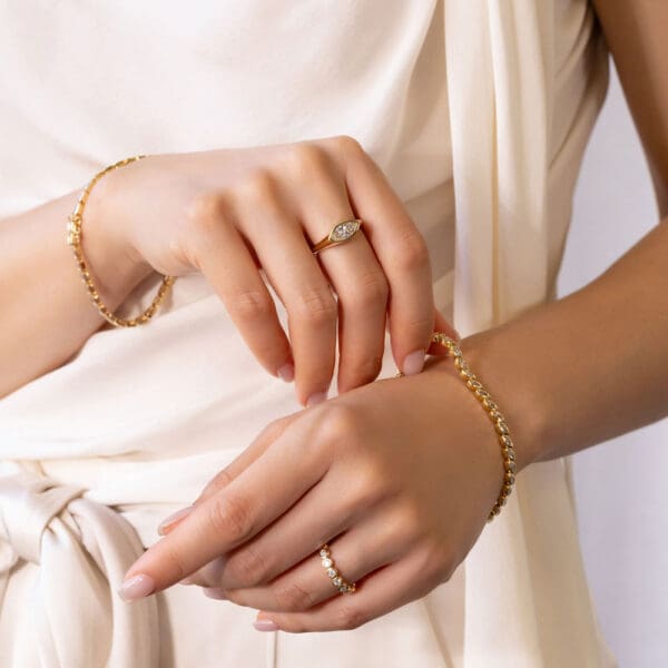 Model Wears Jolene Marquise Yellow Gold Diamond Knife Edge Ring Roxie 2 5 Moissanite Round Bezel Priya Bezel Tennis Bracelet