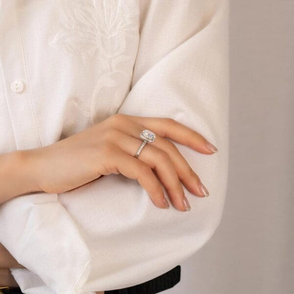 Model Wears Katrina White Gold Moissanite Hidden Knife Edge Cushion Halo Ring