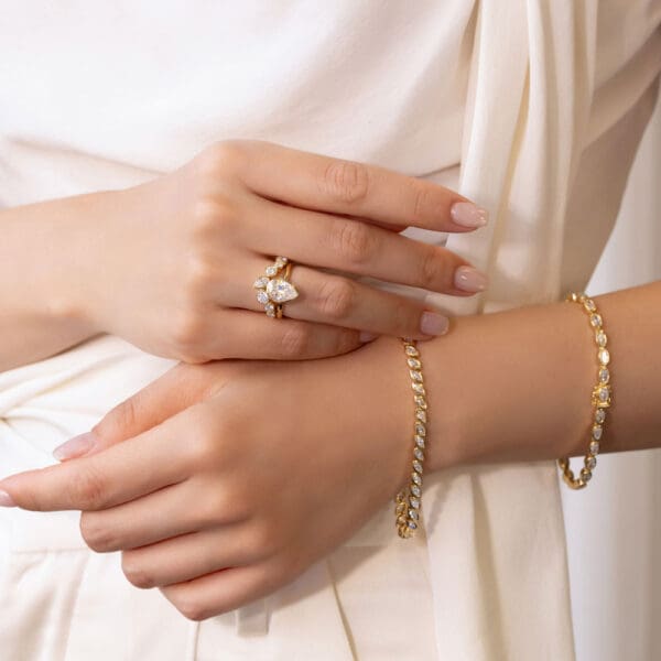 Model Wears Lottie Pear 10X7 Yellow Gold Moissanite Kerry Bezel Scattered Tiara Ring Priya Diamond Marquise Tennis Bracelet