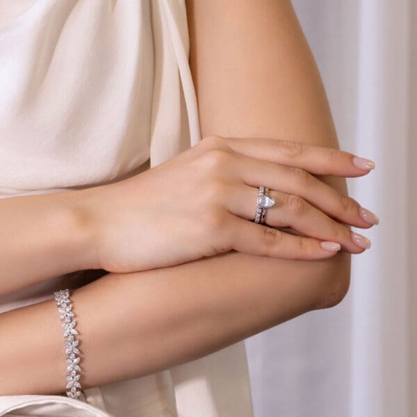 Model Wears Lottie Pear 9X6 White Gold Moissanite Solitaire Ring Roxie 2 0 Round Bezel Set Band