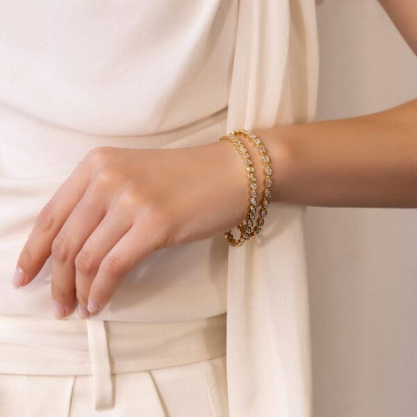 Model Wears Yellow Gold Lab Grown Diamond Petra Oval Priya Marquise Bezel Tennis Bracelet