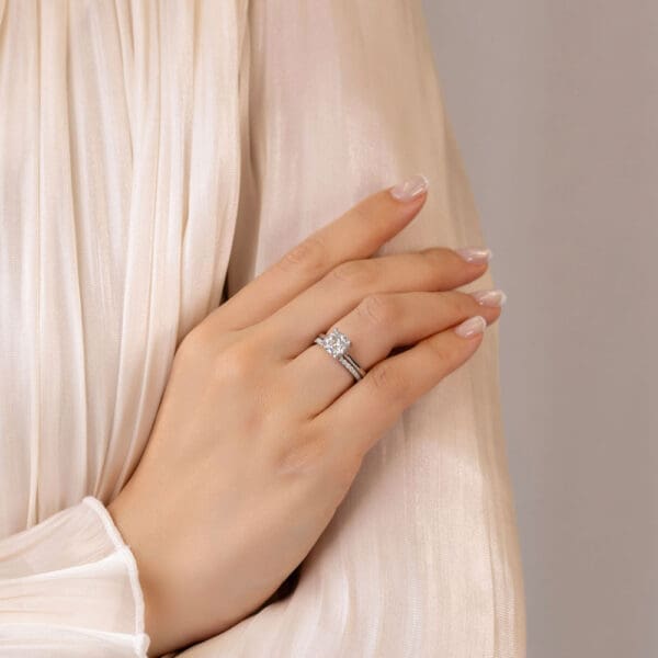 Model Wears Hattie Cushion 7 5 White Gold Diamond Accented Under Rail Bridge Ring Angelica 1 5 U Prong Set Wedding Ring