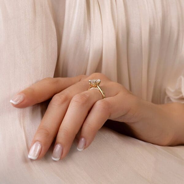 Model Wears Monet Marquise 2 01Ct Yellow Gold Lab Grown Diamond 5 Prong Petal Basket Accented Bridge Engagement Ring