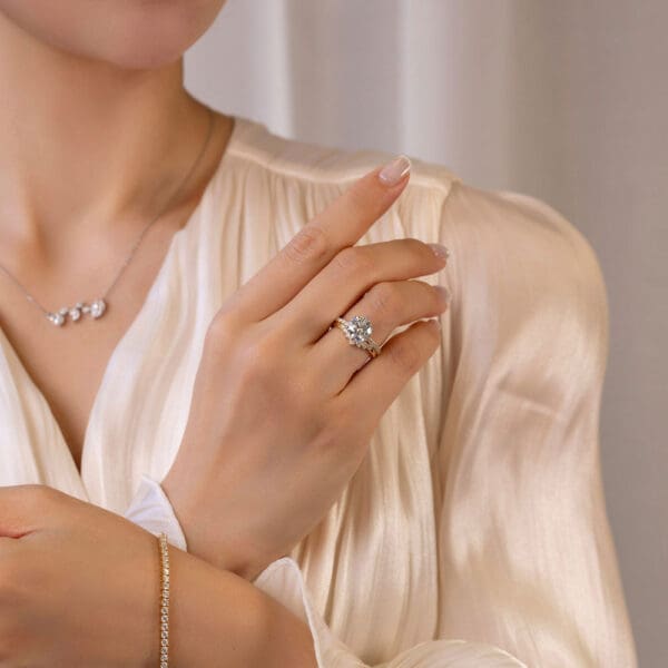 Model Wears Petunia Round 2 01Ct White Gold Diamond Interlocking Petal Basket Ring Hayden Graduated Round Tiara Jigsaw Ring