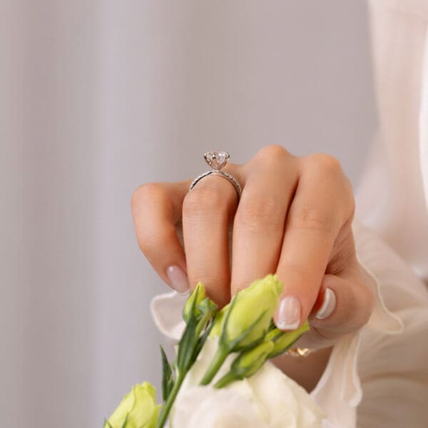Model Wears Petunia Round 2 01Ct White Gold Lab Grown Diamond Prong Set Interlocking Petal Basket Engagement Ring