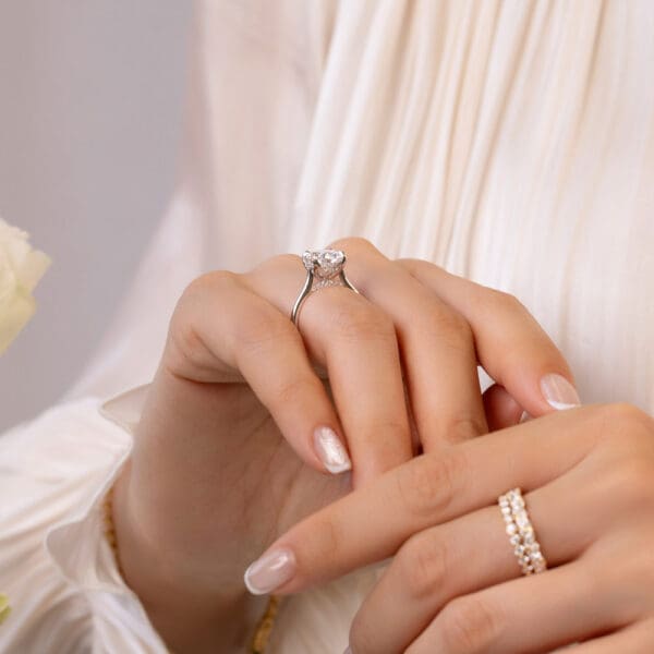 Model Wears Primrose Oval 3 03Ct White Gold Lab Grown Diamond Petal Basket Underrail Accented Bridge Engagement Ring