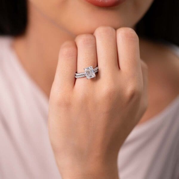 Model Wears Harmony Emerald 9X7 Diamond Under Rail Bridge Accents Ring With Angelica 1 5 White Gold Band