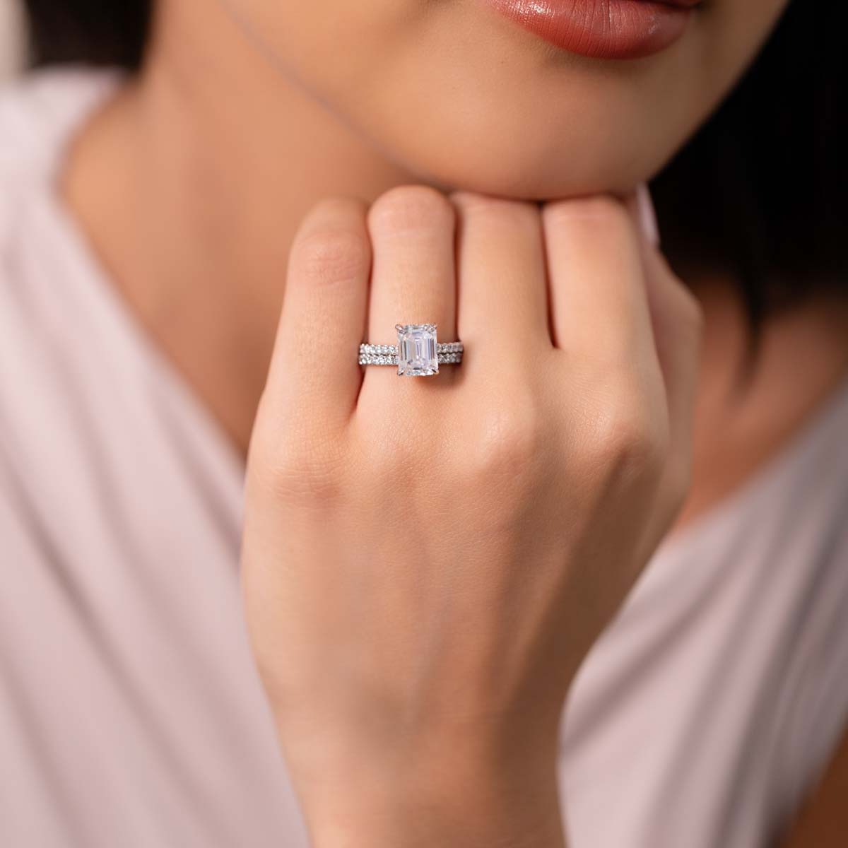 Model Wears Harmony Emerald 9X7 White Gold Under Rail Bridge Accents Ring With Angelica 1 5 Diamond Band