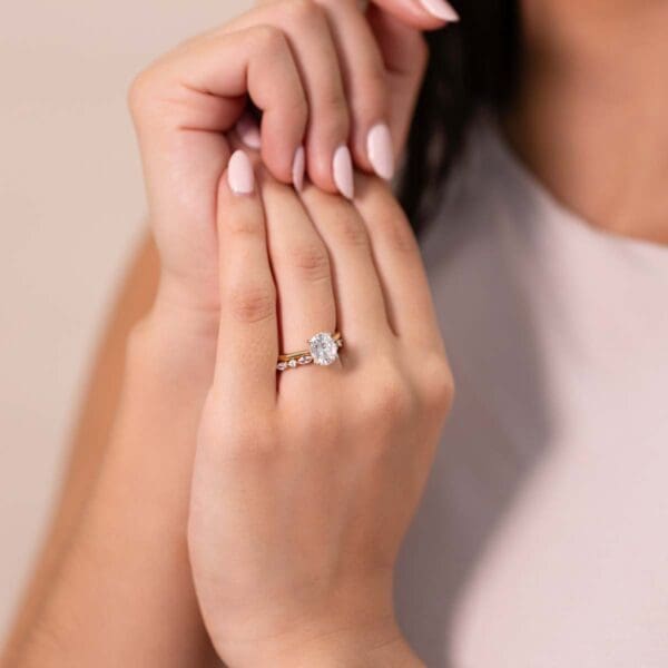 Model Wears Hattie Oval 9X7 Diamond Under Rail Bridge Accents Tapered Ring With Evie Alternating Yellow Gold Band