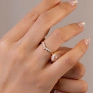 Model Wears Hayden Yellow Gold Moissanite Graduated Round Tiara Jigsaw Prong Set Wedding Ring Blog Post