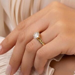 Model Wears Peony 8 0 Yellow Gold Moissanite Split Band 6 Prong Leaf Design Solitaire Ring Blog Post
