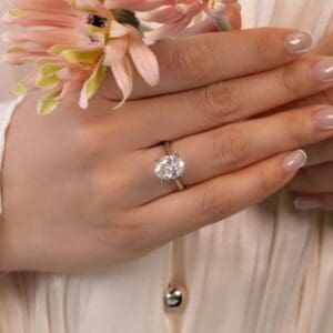 Model Wears Primrose Oval 3 03Ct White Gold Lab Grown Diamond Underrail Accented Bridge Petal Basket Engagement Ring Blog Post