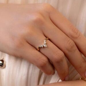 Model Wears Sofie Yellow Gold Moissanite Pear And Round Tiara Style Jigsaw Band Wedding Ring Blog Post